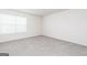 Neutral bedroom showcases plush carpeting, white walls, and a window with blinds at 282 Limestone Circle, Conyers, GA 30013