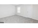 Carpeted bedroom with window and closet door at 282 Limestone Circle, Conyers, GA 30013