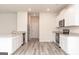 Open concept kitchen featuring stainless steel appliances, white cabinets and stone countertops at 282 Limestone Circle, Conyers, GA 30013