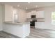 Modern kitchen featuring white cabinets, stainless steel appliances, granite countertops and hard surface floors at 282 Limestone Circle, Conyers, GA 30013