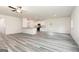 Spacious open-concept living area featuring hard surface floors, white walls, and an adjoining kitchen at 282 Limestone Circle, Conyers, GA 30013