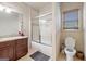 Bright bathroom featuring a tub-shower combo, granite vanity, and tiled floors at 1484 Mcpherson Se Ave, Atlanta, GA 30316