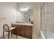 Bathroom featuring a vanity with granite countertops, a large mirror, and a shower with glass doors at 1484 Mcpherson Se Ave, Atlanta, GA 30316