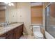 Bathroom featuring a vanity with granite countertops, a toilet, and a shower with glass doors at 1484 Mcpherson Se Ave, Atlanta, GA 30316