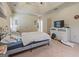 Cozy bedroom offering tray ceilings, white trim, carpet, and a dresser with a television at 1484 Mcpherson Se Ave, Atlanta, GA 30316