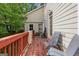 Outdoor deck with red railings, chairs, and an exterior door at 1484 Mcpherson Se Ave, Atlanta, GA 30316
