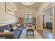 Inviting living room featuring a large sofa, neutral carpet, and windows allowing natural light to fill the space at 1484 Mcpherson Se Ave, Atlanta, GA 30316