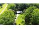 An aerial view featuring the home with a long driveway surrounded by green trees at 1833 S Highway 92, Fayetteville, GA 30215