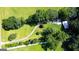 An aerial view of the property with a long driveway winding through green grass and trees at 1833 S Highway 92, Fayetteville, GA 30215
