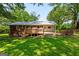 Spacious backyard with a wooden deck, brick accents and plenty of shade at 1833 S Highway 92, Fayetteville, GA 30215