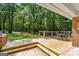 Backyard featuring a wooden deck, table and chairs with green landscaping at 1833 S Highway 92, Fayetteville, GA 30215