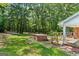 Backyard with patio, brick barbecue and view of wooded lot at 1833 S Highway 92, Fayetteville, GA 30215