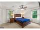 Well-lit bedroom featuring a ceiling fan and two windows for ample natural light and comfort at 1833 S Highway 92, Fayetteville, GA 30215