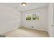 Simple bedroom with carpet flooring and a bright window, offering a serene and inviting space at 1833 S Highway 92, Fayetteville, GA 30215