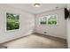 Inviting bedroom featuring two bright windows and a television, offering comfort and entertainment at 1833 S Highway 92, Fayetteville, GA 30215