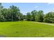 The residence is surrounded by a large expanse of lush, green grass and mature trees at 1833 S Highway 92, Fayetteville, GA 30215