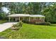 Charming brick home with a metal roof, carport, and lush green lawn at 1833 S Highway 92, Fayetteville, GA 30215