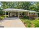Inviting brick home featuring a carport, covered entry, and manicured landscaping at 1833 S Highway 92, Fayetteville, GA 30215
