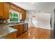 Kitchen featuring granite countertops, stainless steel appliances, hardwood floors and wood cabinets at 1833 S Highway 92, Fayetteville, GA 30215