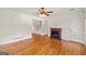 Living room with hardwood floors, ceiling fan, white walls and a decorative fireplace at 1833 S Highway 92, Fayetteville, GA 30215