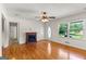 Open living room area has hardwood floors, windows with natural light and decorative fireplace at 1833 S Highway 92, Fayetteville, GA 30215