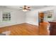 Open living room has hardwood floors, white walls and a ceiling fan at 1833 S Highway 92, Fayetteville, GA 30215