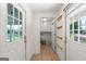 View of the mud room that leads to the laundry with tile floors and white painted walls at 1833 S Highway 92, Fayetteville, GA 30215