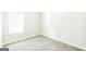 Cozy bedroom featuring neutral walls, plush carpet flooring, and a bright window at 2655 Virginia Cv, Riverdale, GA 30296
