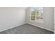 Carpeted bedroom with a large window offering plenty of natural light at 2655 Virginia Cv, Riverdale, GA 30296