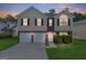 Charming two-story home with a well-maintained lawn, two-car garage, and brick and vinyl siding at 2655 Virginia Cv, Riverdale, GA 30296