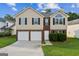 Charming two-story home with a well-maintained lawn, two-car garage, and brick and vinyl siding at 2655 Virginia Cv, Riverdale, GA 30296