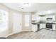 Well-lit kitchen with white cabinets, stainless steel appliances, and new hard surface floors at 2655 Virginia Cv, Riverdale, GA 30296