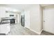 Well-lit kitchen with white cabinets, stainless steel appliances, and new hard surface floors at 2655 Virginia Cv, Riverdale, GA 30296