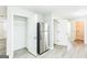 Spacious kitchen with stainless steel refrigerator, white cabinets, and new hard surface floors at 2655 Virginia Cv, Riverdale, GA 30296