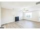 Cozy living room featuring hard surface floors, fireplace, neutral paint, and ceiling fan at 2655 Virginia Cv, Riverdale, GA 30296