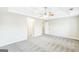 Spacious main bedroom with a ceiling fan, tray ceiling, and neutral carpeting at 2655 Virginia Cv, Riverdale, GA 30296