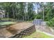 Backyard area featuring a shed, a play area, and a wooded backdrop at 539 Riverbirch Trce, Stone Mountain, GA 30087