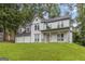 Charming two-story home with a covered front porch and attached two-car garage surrounded by mature trees at 539 Riverbirch Trce, Stone Mountain, GA 30087