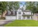 Charming two-story home with a covered front porch, attached two-car garage and a lush green lawn at 539 Riverbirch Trce, Stone Mountain, GA 30087