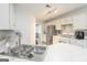 The kitchen offers white cabinetry, stainless steel appliances and stylish backsplash that adds style to the space at 539 Riverbirch Trce, Stone Mountain, GA 30087
