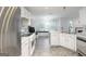 The kitchen features white cabinets, stainless steel appliances and ample counter space, perfect for cooking at 539 Riverbirch Trce, Stone Mountain, GA 30087