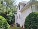 Side of house with a stucco exterior, complemented by lush greenery and well-maintained landscaping at 2911 Chesterfield Se Way, Conyers, GA 30013