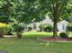 Beautiful exterior of a well-maintained home with a lush green lawn and mature trees, creating a serene setting at 2911 Chesterfield Se Way, Conyers, GA 30013