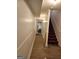 Hallway with wood-look floors that leads towards a stairwell and other parts of the home at 2911 Chesterfield Se Way, Conyers, GA 30013