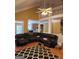 Open-concept living room featuring a large leather sectional and high ceilings, creating an inviting atmosphere at 2911 Chesterfield Se Way, Conyers, GA 30013
