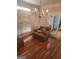 Cozy living room featuring hardwood floors, chair, and elegant chandelier at 2911 Chesterfield Se Way, Conyers, GA 30013