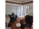 Untidy living room featuring wood floors and white walls with decorative trim at 2911 Chesterfield Se Way, Conyers, GA 30013
