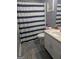 Bathroom features a shower with striped curtain, vanity with sink, and modern fixtures at 1524 Queen Elizabeth Dr, Locust Grove, GA 30248