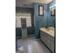 The bathroom has a sink with a vanity and a cabinet next to a window at 1524 Queen Elizabeth Dr, Locust Grove, GA 30248