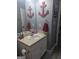 Bathroom featuring vanity with sink, framed mirror, and a decorative anchor on the wall at 1524 Queen Elizabeth Dr, Locust Grove, GA 30248